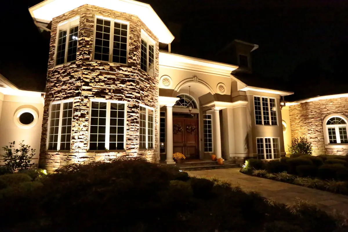 Stone-front residence washed with low-voltage landscape lighting